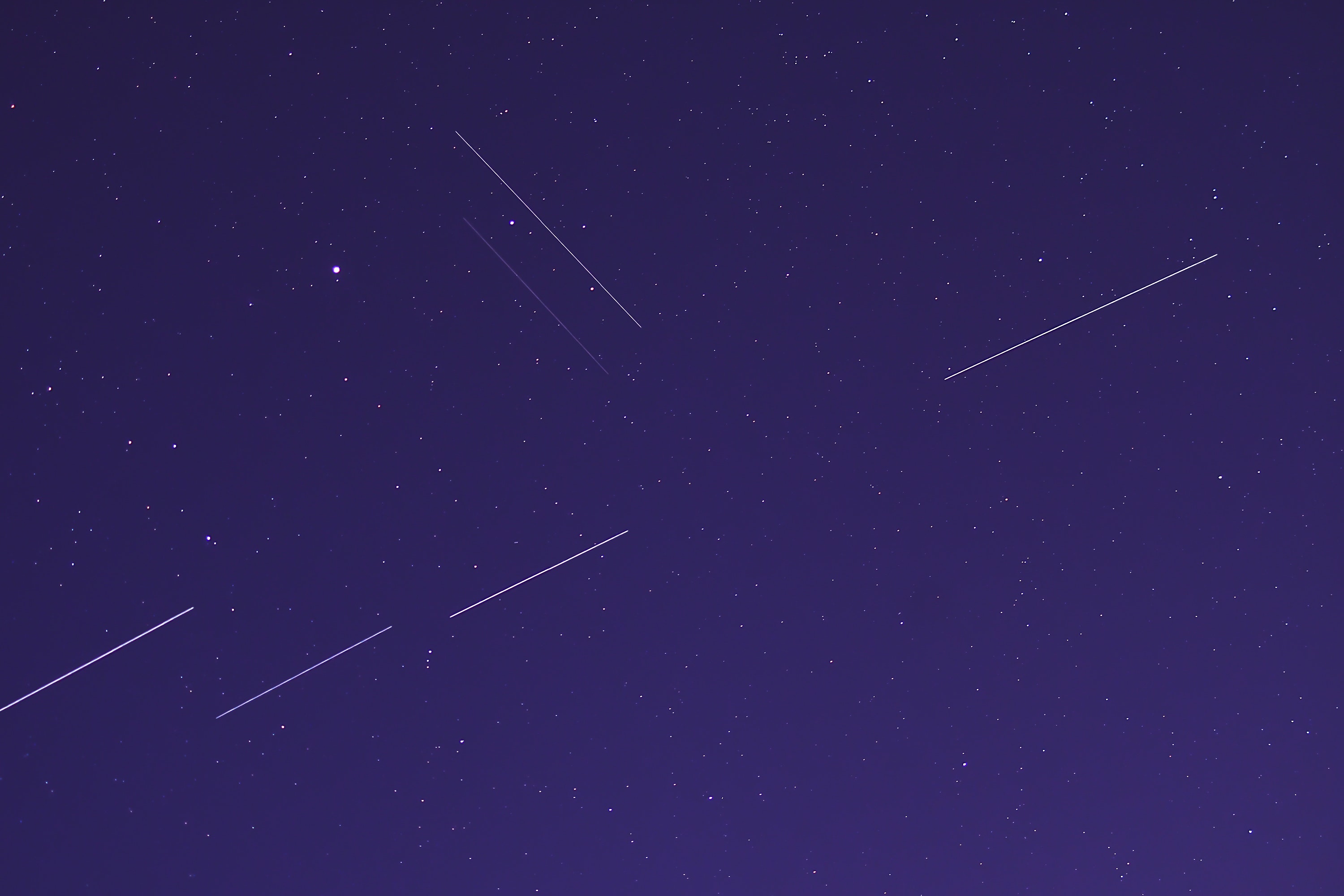 Satellites leaving streaks in the night sky.